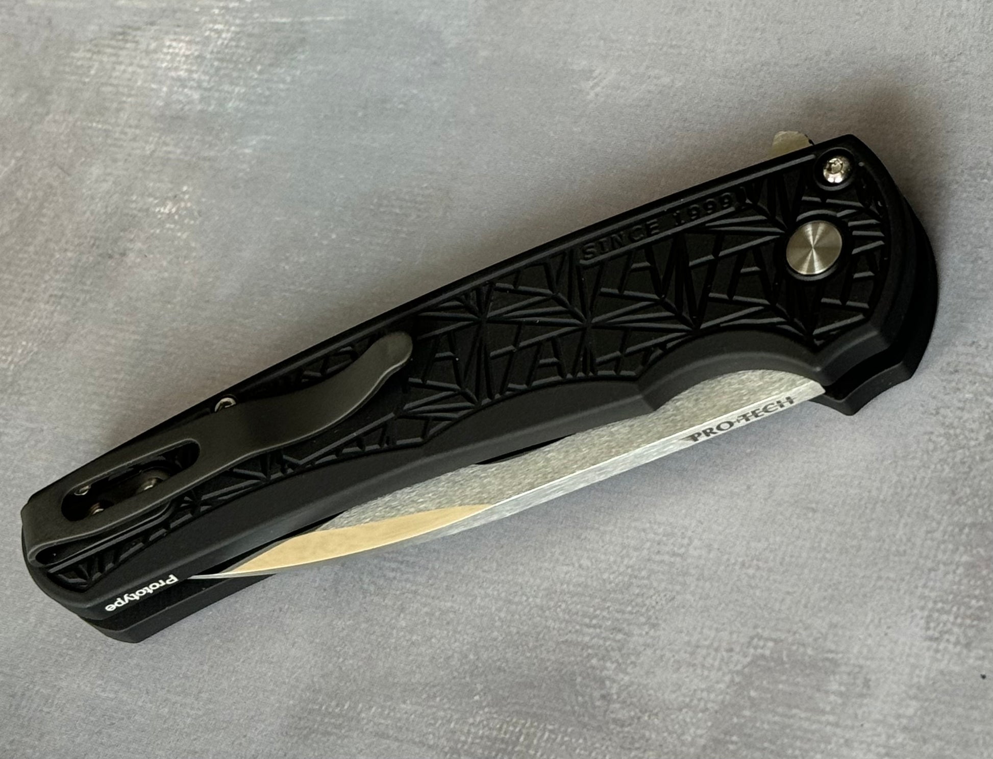 Pro-Tech Custom Malibu Nexus (2024 Malibu Custom 001) - 25 Year Anniversary Pattern Milled Handle - Mike Irie Compound Hand Ground Mirror Polish Wharncliffe Blade - Black Pearl Inlaid Push Button - Black DLC Titanium Clip /100 "Prototype" Urban Cutlery & Lifestyle Shoppe